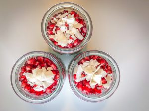 Three Weck jars filled with chia pudding and pomegranate