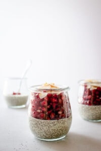 Several small jars of chia pudding and fruit