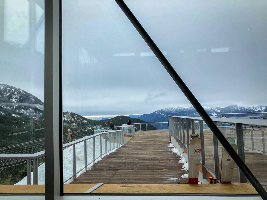 A patio with railing outside a mountaintop lodge