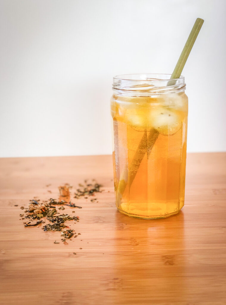 Glass filled with iced tea and a straw on a counter