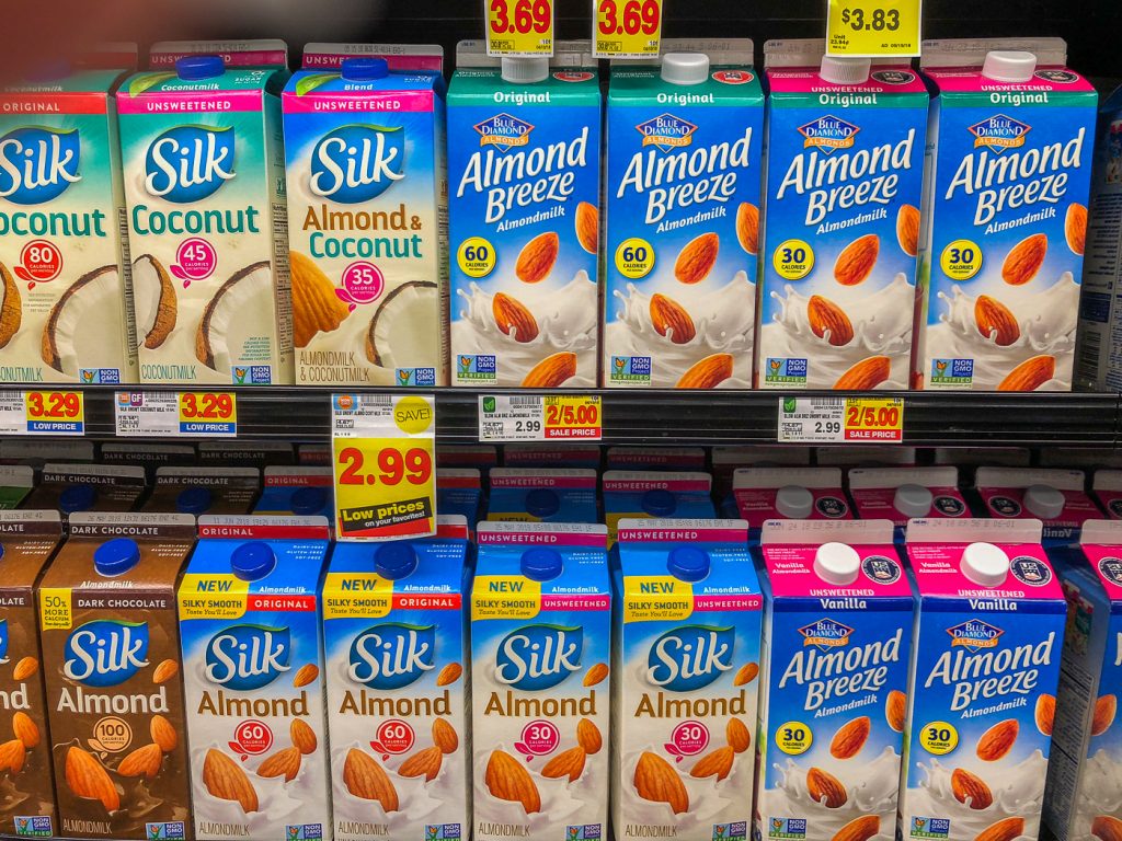 Grocery store refrigerated shelf of non-dairy milk cartons