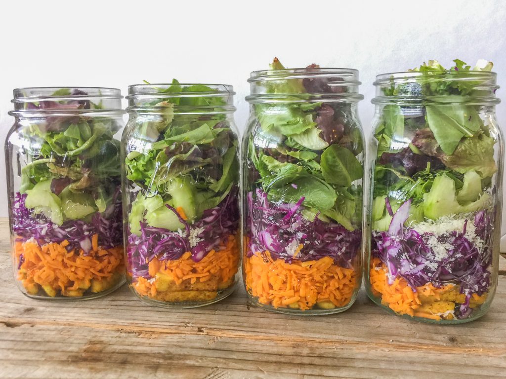 4 quart mason jars layered with vegetables