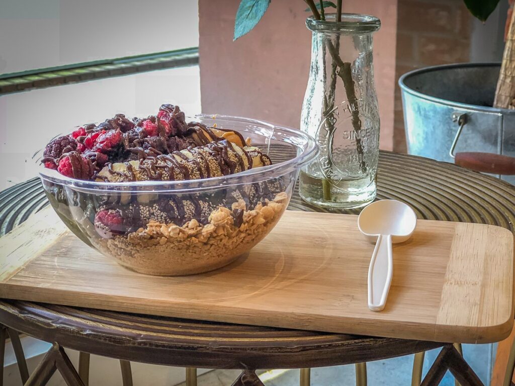 Smoothie bowl topped with chocolate and fruit