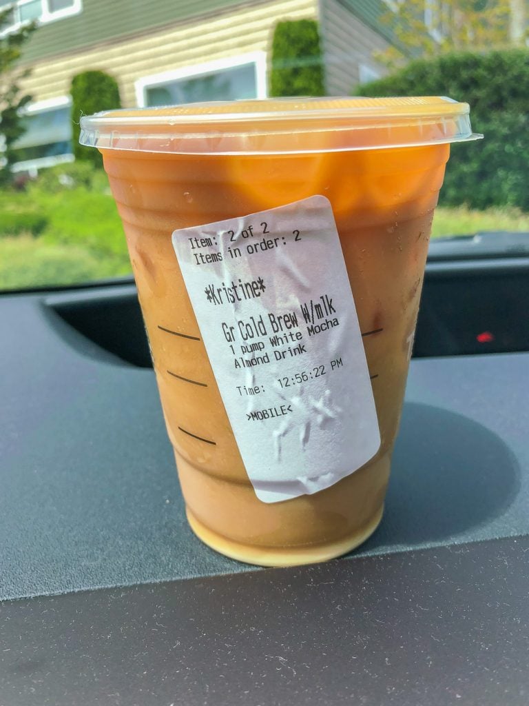 Starbucks cup with order sticker on car dash