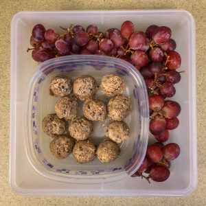 Plastic container with grapes and energy balls