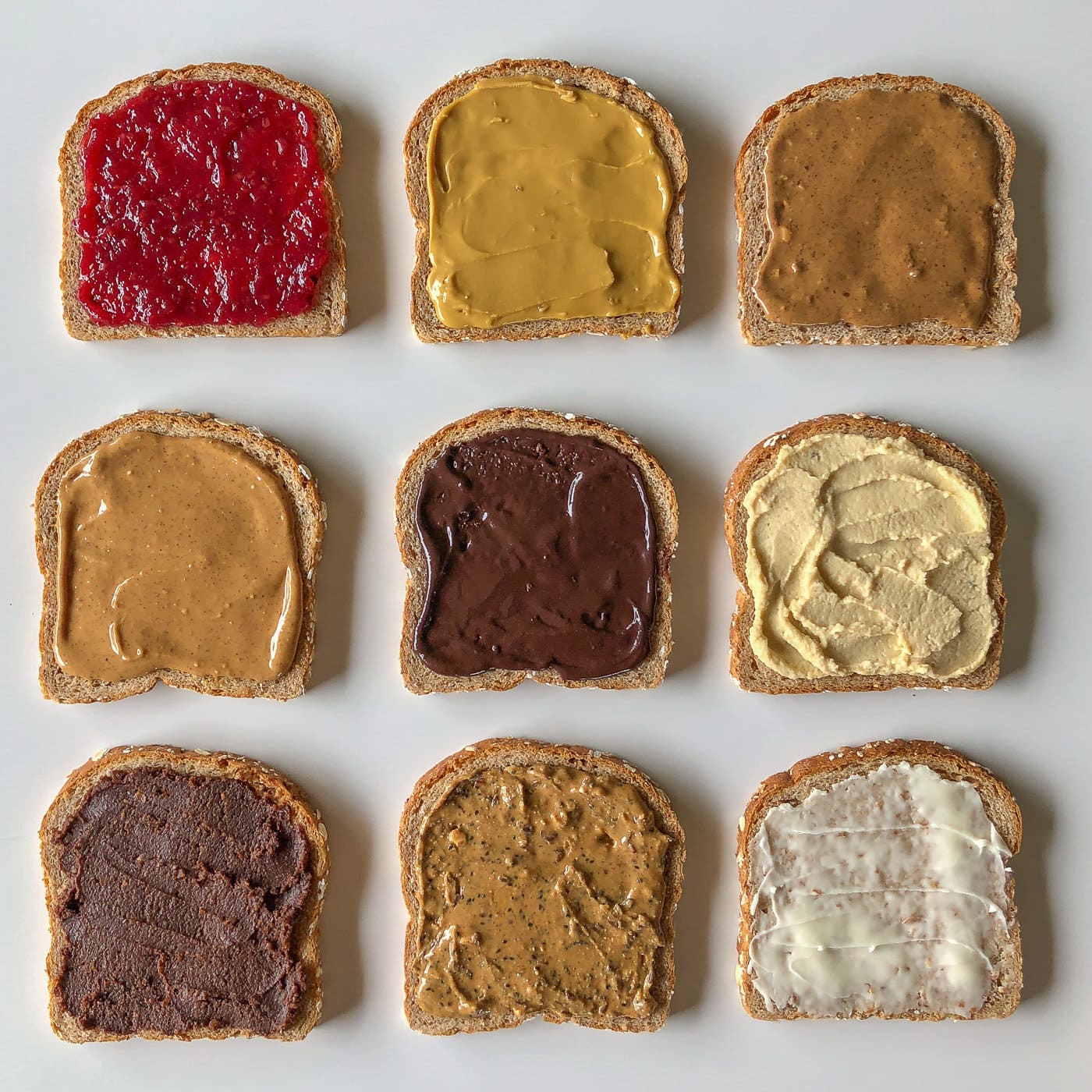 9 pieces of bread each covered with a different spread