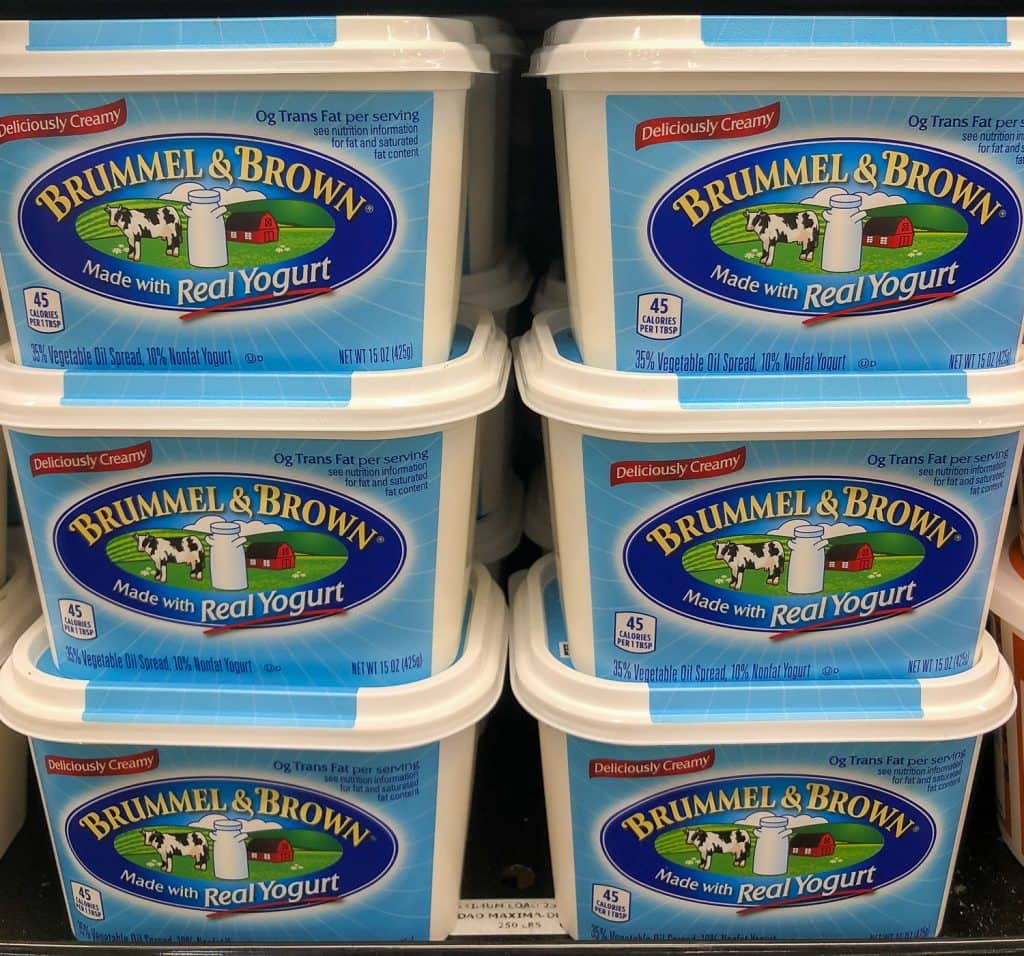 6 tubs of margarine on a grocery store shelf