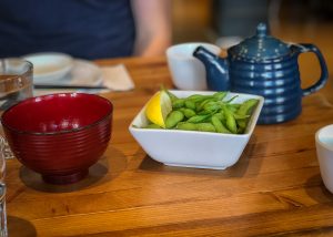 White bowl of edamame pods