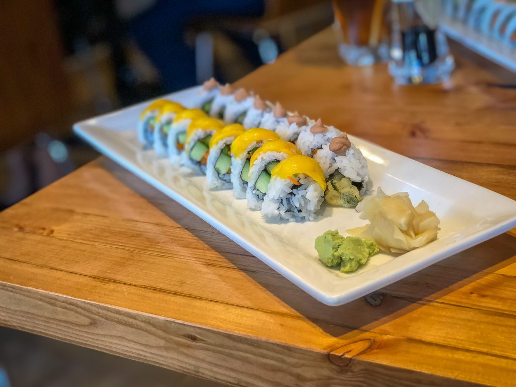 Oblong late covered with sushi rolls