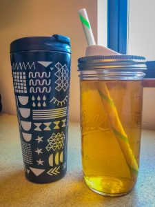 Travel mug and canning jar full of hot tea and iced tea