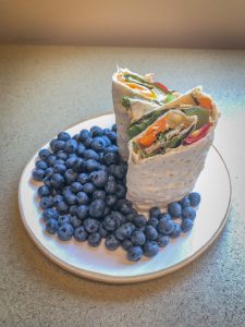 Wrap sandwich on a plate with blueberries