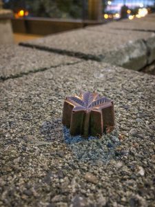 Piece of chocolate shaped like a maple leaf