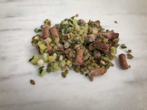 Pumpkin seeds, avocado, etc. on a marble surface