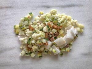 Frozen chopped veggies for a smoothie on a marble counter