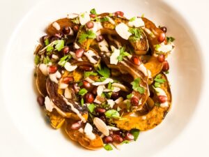 Sliced delicata squash with pomegranate