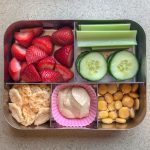Bento box filled with berries, celery and beans