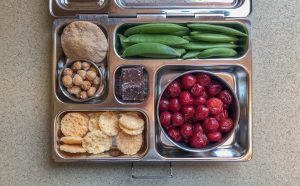 Bento box with sour cherries and snap peas