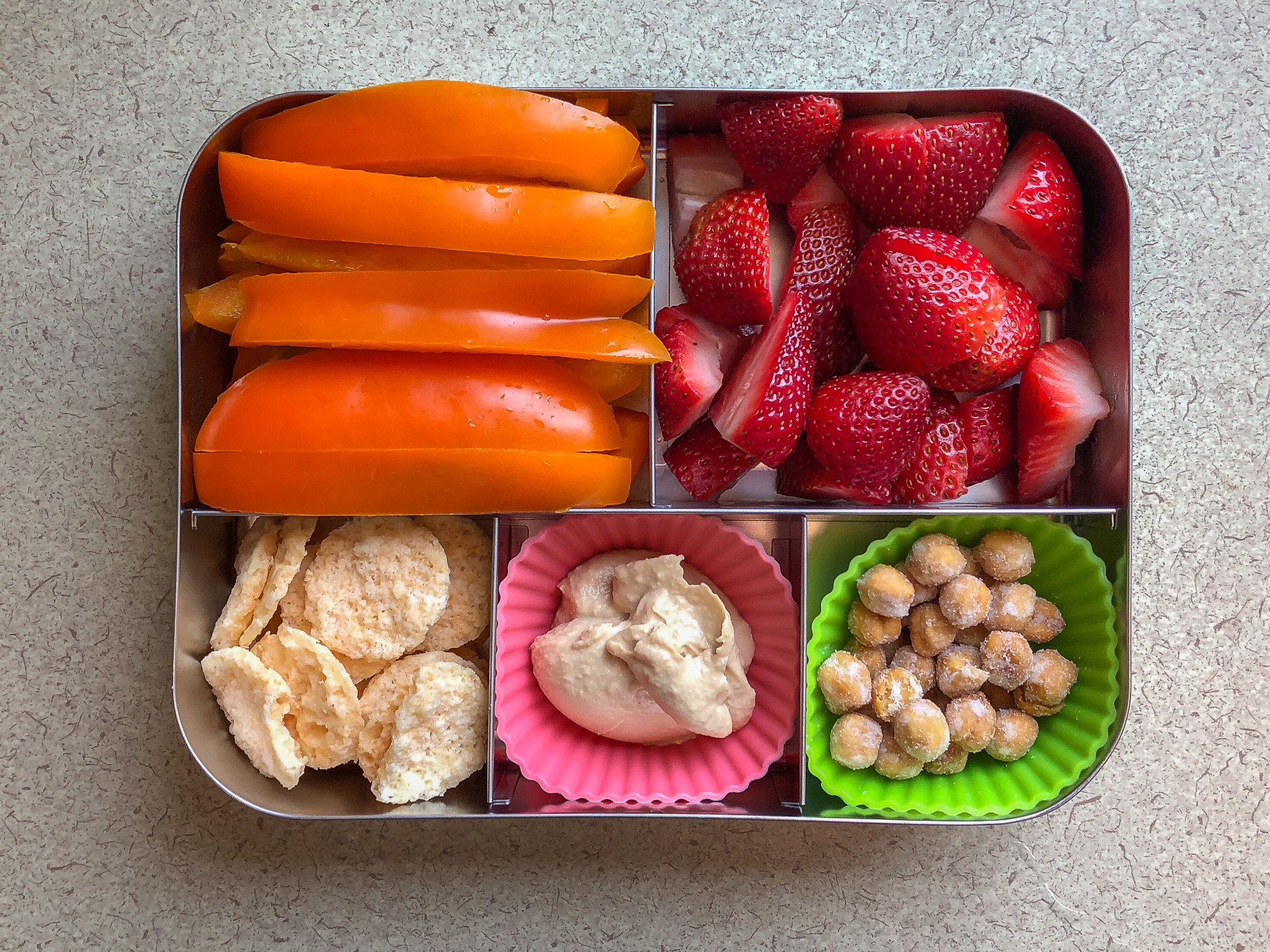 Bento box filled with bell pepper and strawberries