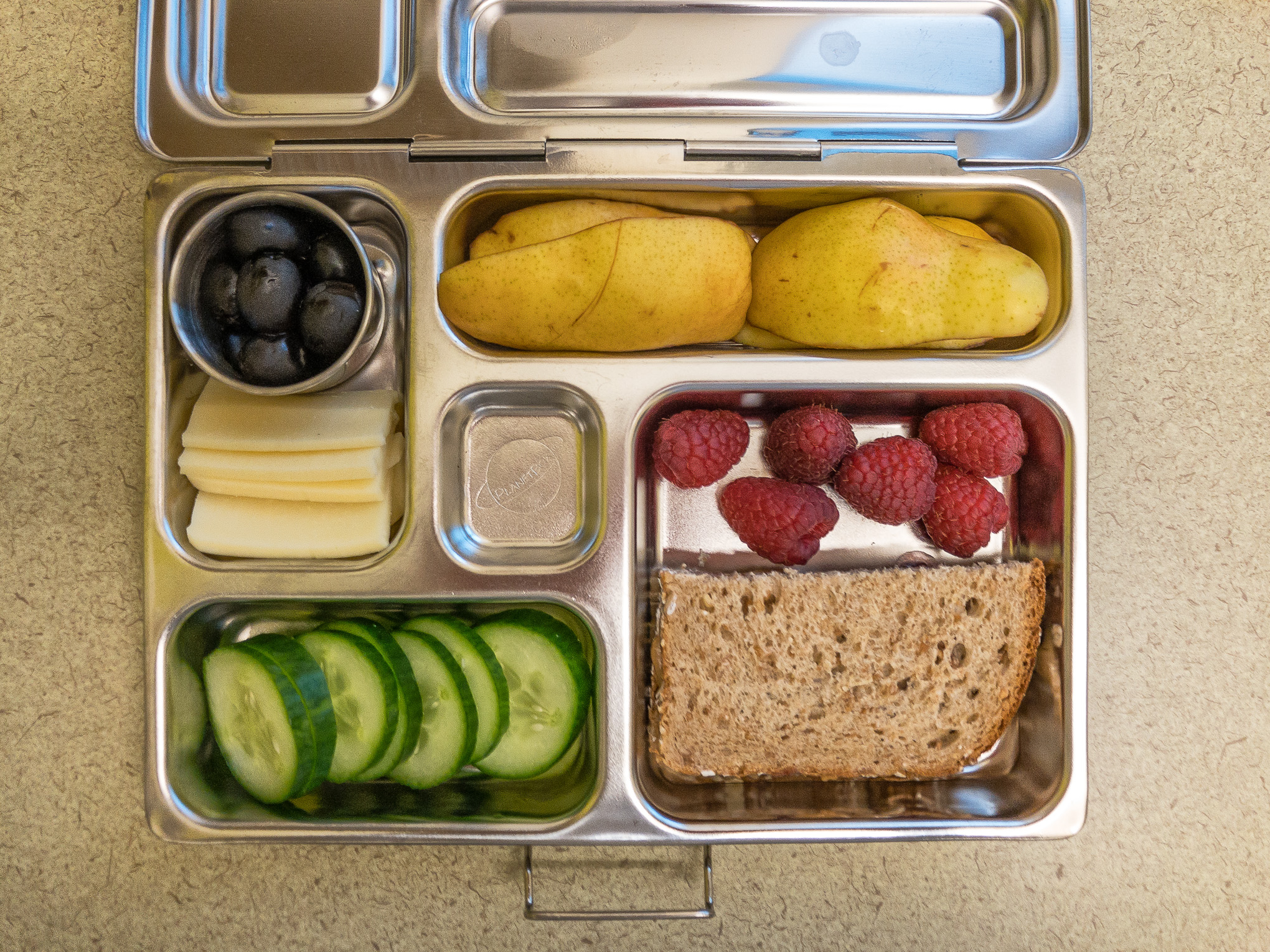 Bento box filled with pear and a sandwich