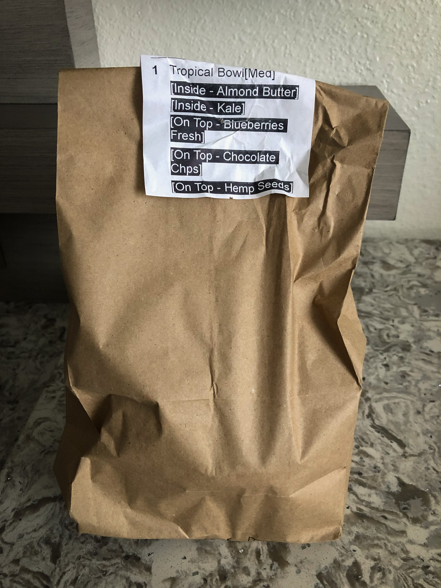 Paper bag with food order stapled to the front