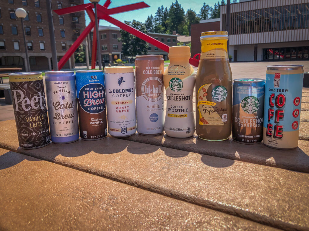 Cans of iced coffee on a picnic table