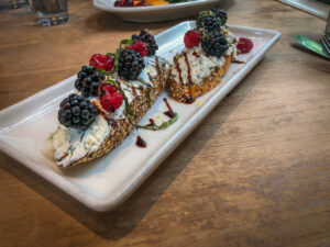 Bruschetta on a plate topped with berries