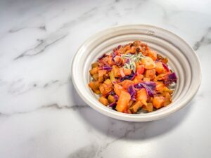 Bowl of cooked veggies and apples