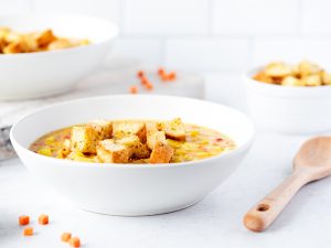 Bowl of corn chowder with croutons