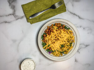Top down bowl of beans, greens and cheese