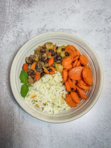 Top down of bowl filled with beans rice and veggies