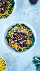 Top down view of bowl of greens and beans