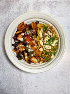 Town down pic of a bowl with veggies and couscous