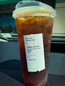 Cup of iced tea on dashboard of car