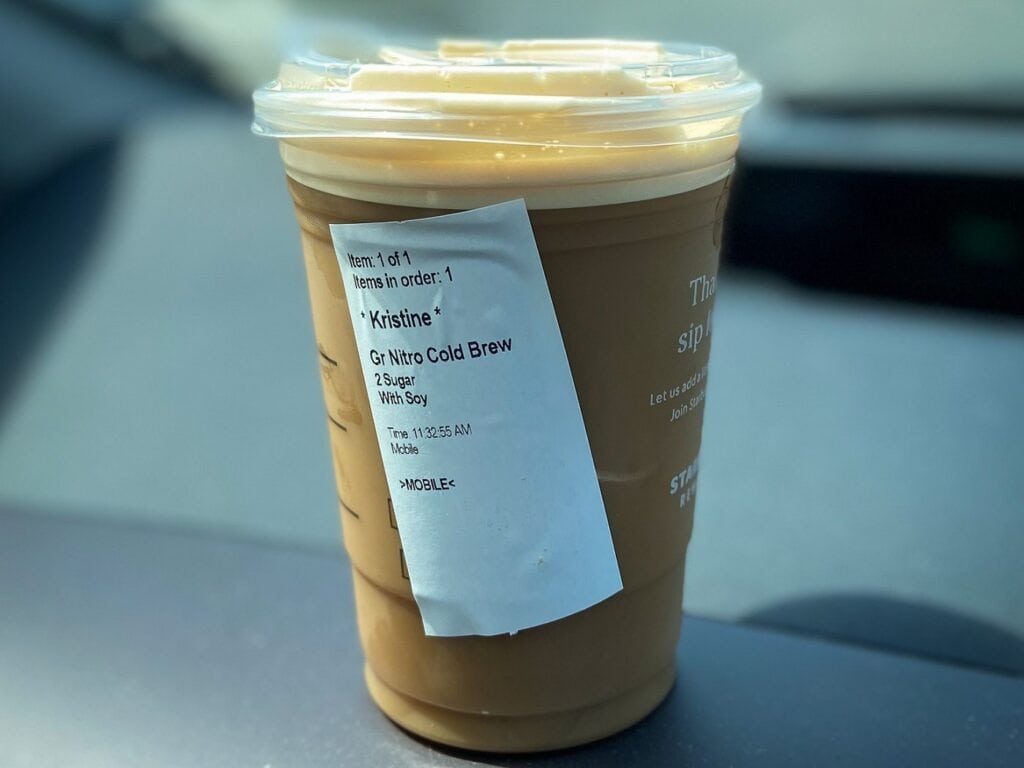Starbucks nitro coldbrew in a to go cup on car dashboard