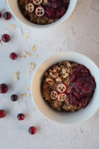 Top down view of a bowl of hot cereal with cranberries and pecans
