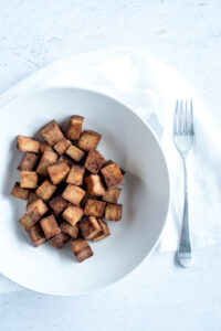 Top down view of a white bowl filled with tofu