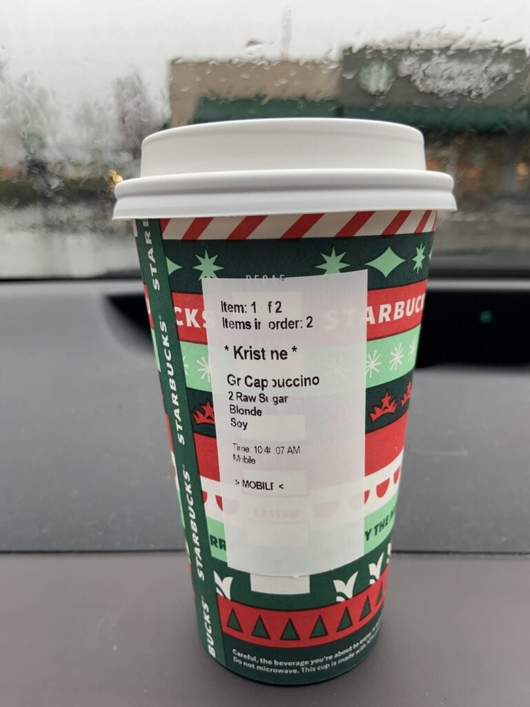 Starbucks cup on a dashboard of a car