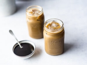 Two mason jars filled with soymilk mixed with molasses
