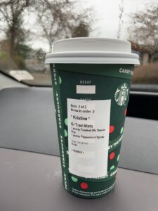 Starbucks cup on a dashboard of a car