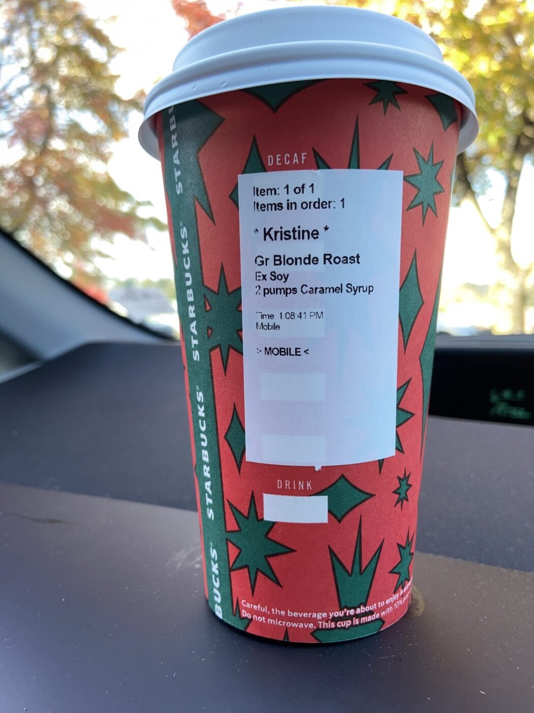 Starbucks cup on a dashboard of a car