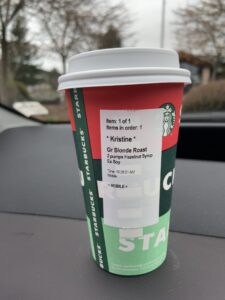 Starbucks cup on a dashboard of a car