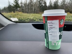 Starbucks cup on a dashboard of a car