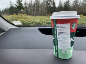 Starbucks cup on a dashboard of a car