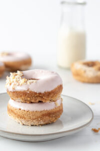 Breakfast scene with two stacked pink donuts on a plate