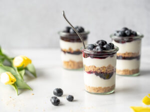 Three jars of blueberry cheesecake and some tulips