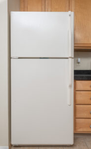 beige freezer on top refrigerator