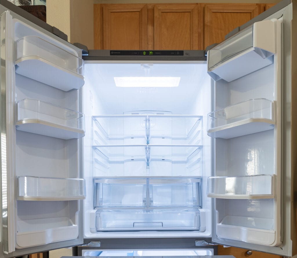 Empty refrigerator with doors open