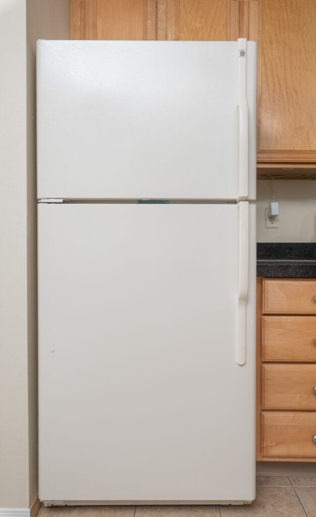 beige freezer on top refrigerator