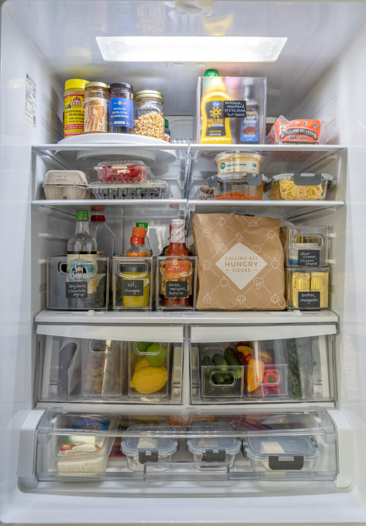 Refrigerator full of food several shelves