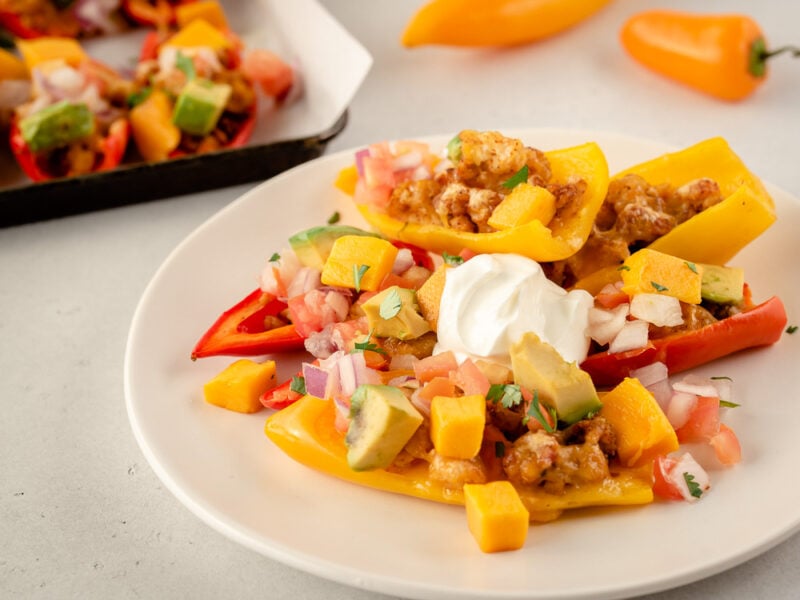 Plate with mini pepper nachos and sour cream
